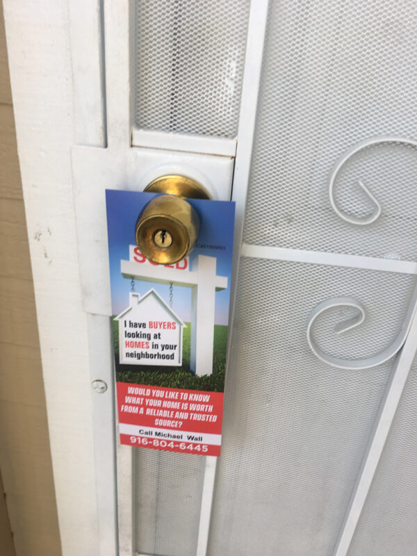 real_estate_door_hanger_on_the_front_door_of_home